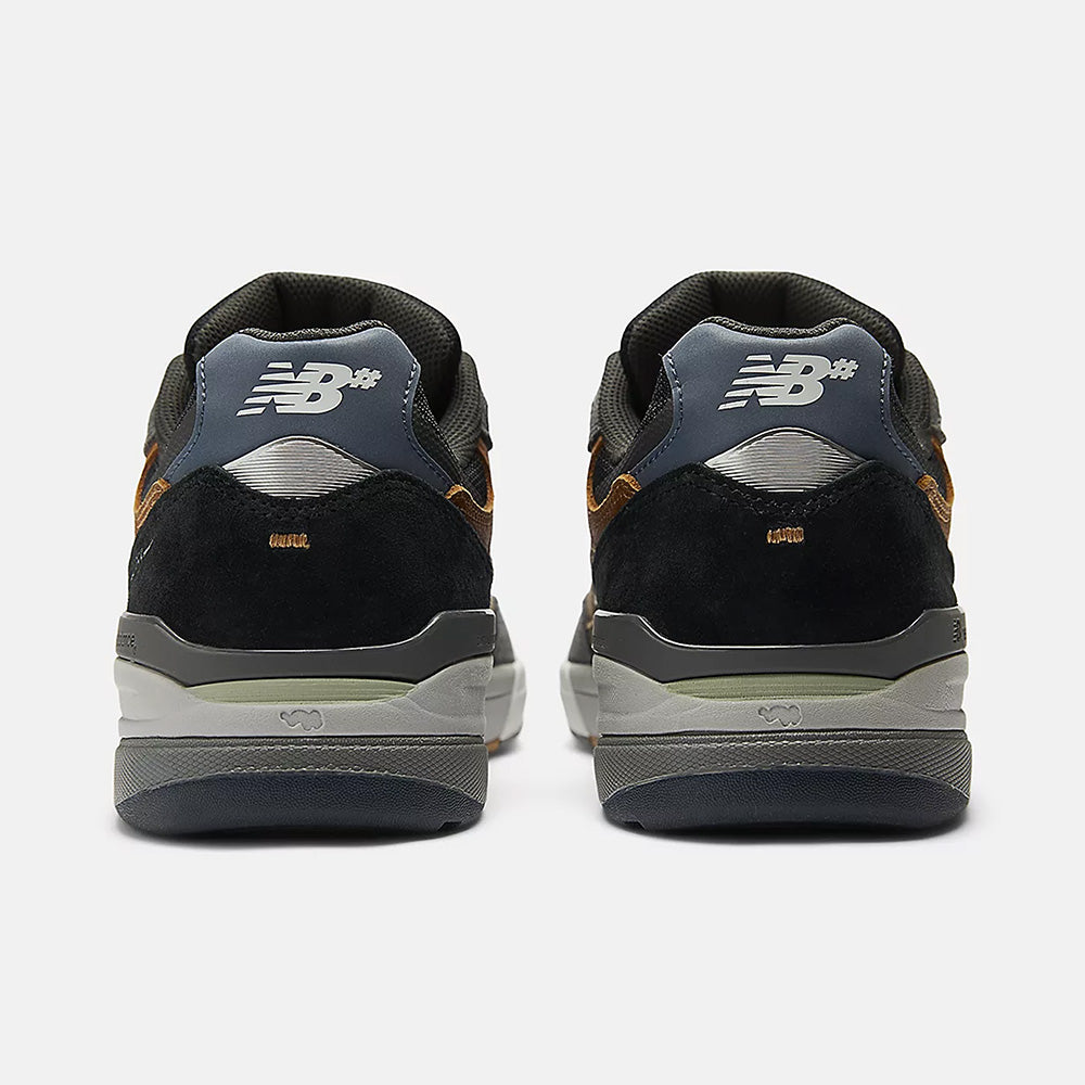 Rear view of NB NUMERIC REYNOLDS 933 CASTLEROCK / VINTAGE INDIGO sneakers in black, grey, and brown with ABZORB cushioning, featuring the NB NUMERIC logo and detailed heels against a white background.