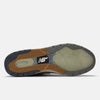The image shows the outsole of the NB NUMERIC REYNOLDS 933 in Castlerock/Vintage Indigo, with gray, gum, and translucent rubber textures plus the NB logo—ideal for skate shoes featuring an ABZORB midsole for superior cushioning.