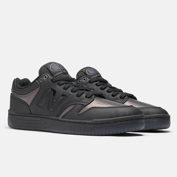 A pair of black NB NUMERIC X BRONZE56K 480 sneakers by NB NUMERIC, featuring leather and mesh panels, flat laces, ABZORB in-sole cushioning, and rubber soles, displayed on a plain white background.