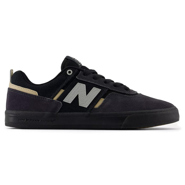 The NB NUMERIC FOY 306 PHANTOM / BLACK sneaker, a collaboration between New Balance Numeric and pro skater Jamie Foy, boasts a flat black sole and is adorned with a gray "N" logo on its black and beige exterior. This vulcanized skate shoe merges style with performance seamlessly.