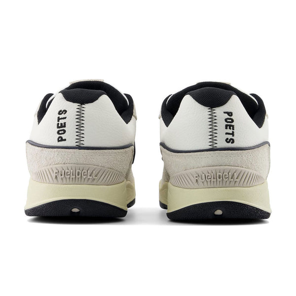 A pair of white and black NB NUMERIC 1010 TIAGO x POETS sneakers.