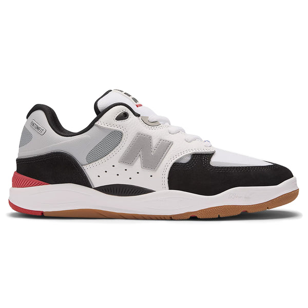 The NB NUMERIC 1010 TIAGO X KAWHI WHITE / BLACK athletic sneaker from NB NUMERIC features a white, black, and gray color combination with a gum sole and red accent on the heel. It is designed for optimal support with responsive FuelCell foam technology.