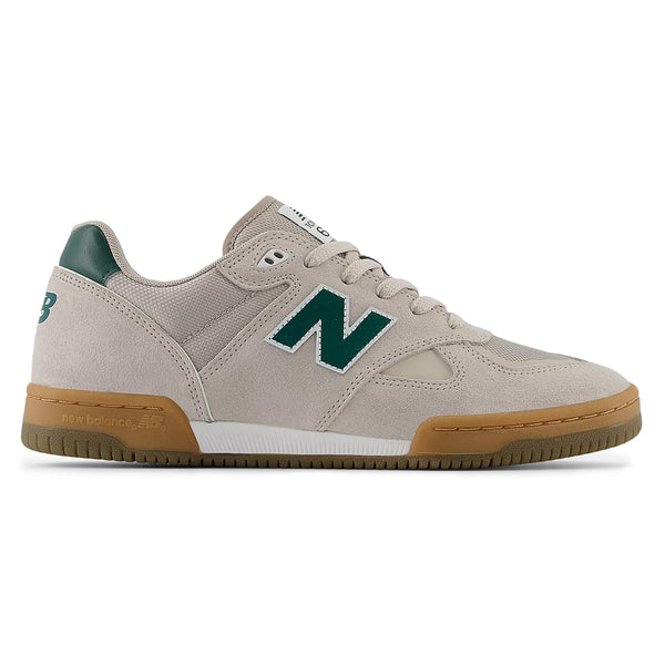 A sneaker from the NB Numeric line in Timber Wolf and Forest Green, featuring Tom Knox's signature style with a prominent "N" logo on the side.