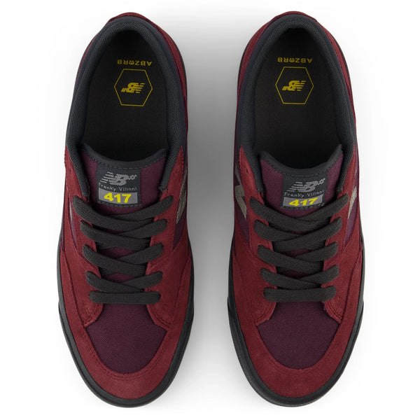 Top view of a pair of maroon and black NB NUMERIC 417 FRANKY VILLANI LOW BURGUNDY / PHANTOM athletic shoes with black laces and yellow accents on the insoles, featuring the number 417 on the tongues. These cupsole skate shoes are perfect for the everyday skater.