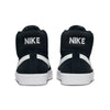 Rear view of a pair of black NIKE SB BLAZER MID BLACK / WHITE sneakers with white soles, the word "NIKE" tastefully printed in white on the back. These versatile skateboarding shoes from nike feature Zoom Air cushioning for enhanced comfort and performance.