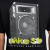 The NIKE SB SOUNDS BANGIN SKATE TEE BLACK by Nike features a large monochrome graphic of a speaker with "NIKE SB" above and "NIKE SB [SOUNDS BANGIN]]]" below in yellow and white text. Made from midweight cotton, this black tee blends style with comfort.