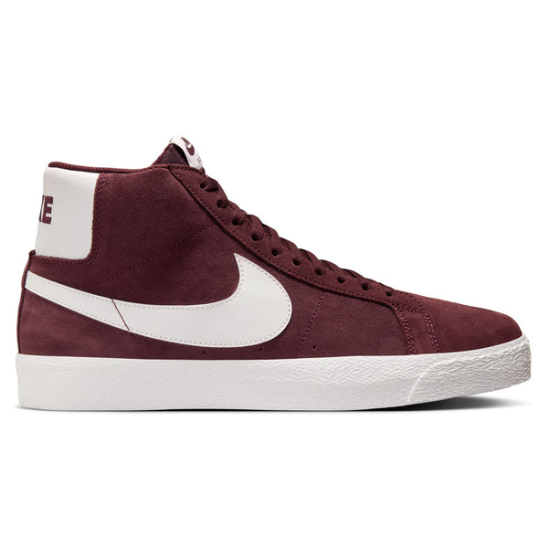 A NIKE SB BLAZER MID BURGUNDY CRUSH / SUMMIT WHITE sneaker with a suede upper, white swoosh, and sole, viewed from the side.