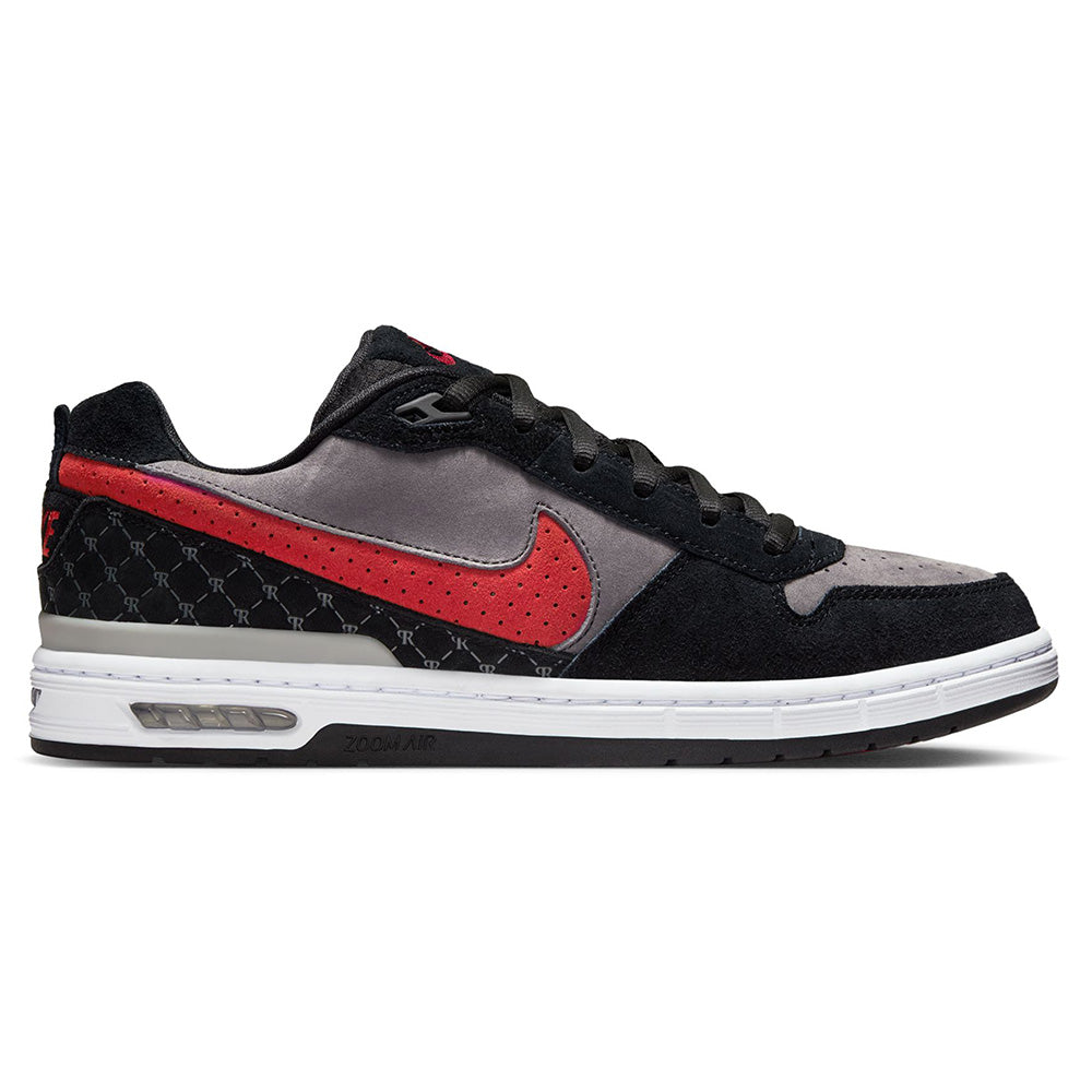 The NIKE SB P-ROD 1 ZOOM AIR LOW in Black/Varsity Red-Flint Grey features premium leather, a red Nike swoosh, black laces, and a white sole with visible Air cushioning—part of nike’s SB Zoom Air line.