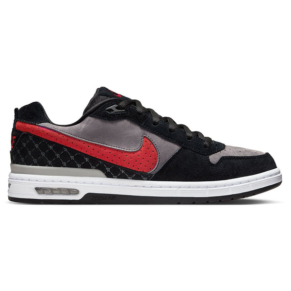 The NIKE SB P-ROD 1 ZOOM AIR LOW in Black/Varsity Red-Flint Grey features premium leather, a red Nike swoosh, black laces, and a white sole with visible Air cushioning—part of nike’s SB Zoom Air line.