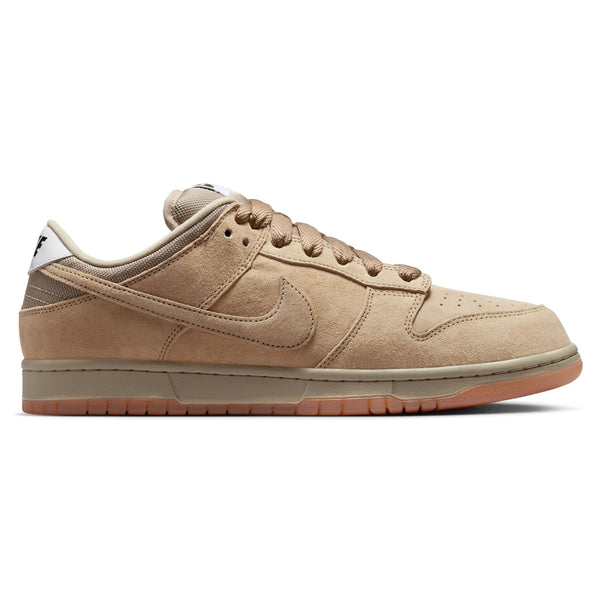 The NIKE SB DUNK LOW PRO B in Parachute Beige by Nike is a tan suede low-top sneaker featuring the swoosh logo, brown laces, and a gum sole—ideal for skateboarding enthusiasts.