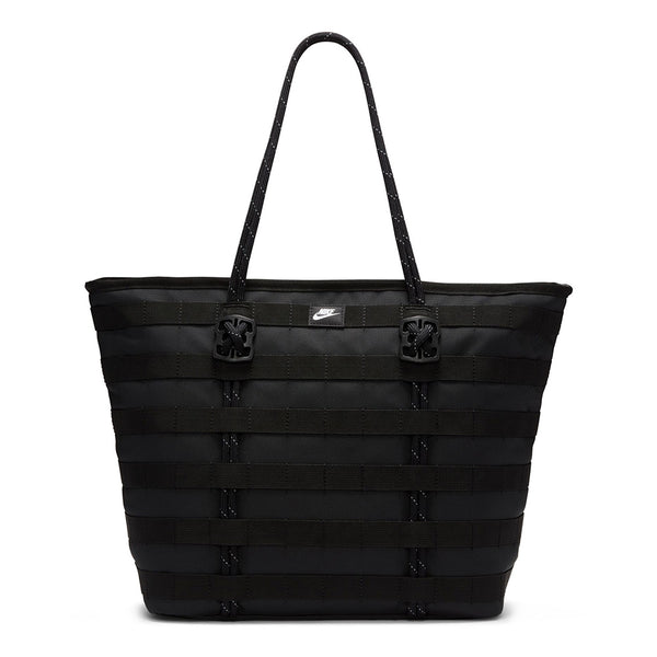 The NIKE RPM TOTE (26L) BLACK is a durable, large tote bag with double handles, horizontal woven details, and a small Nike logo. Made from recycled polyester, it's ideal for daily use and fits your laptop comfortably.