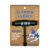 The OLYMPIA SUPPLY SKATE TOOL BLACK by OLYMPIA is shown on branded cardboard packaging with a function list and illustrated dog, making it an essential skateboard accessory.
