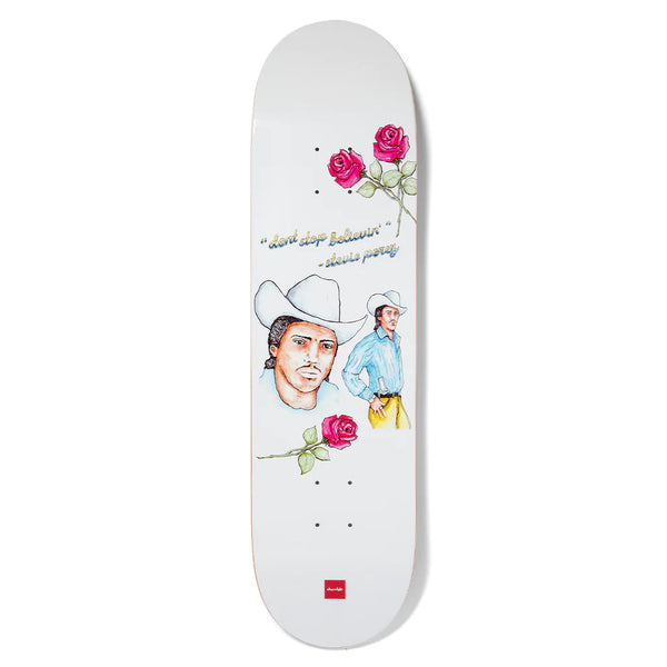 A white CHOCOLATE skateboard with a drawing of a cowboy and roses.