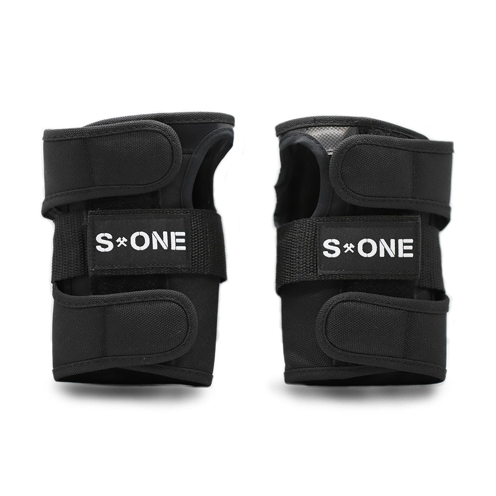 S1 WRIST GUARDS by S1 HELMET CO. are black wrist guards featuring adjustable straps and "S ONE" branding, ideal for pairing with your favorite knee pads or other protective gear.