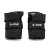 S1 WRIST GUARDS by S1 HELMET CO. are black wrist guards featuring adjustable straps and "S ONE" branding, ideal for pairing with your favorite knee pads or other protective gear.
