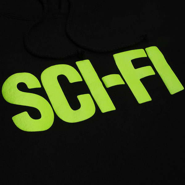 A close-up of the SCI-FI FANTASY BIG SCI-FI HOODIE in black, featuring "SCI-FI" printed in bold, bright yellow-green letters.