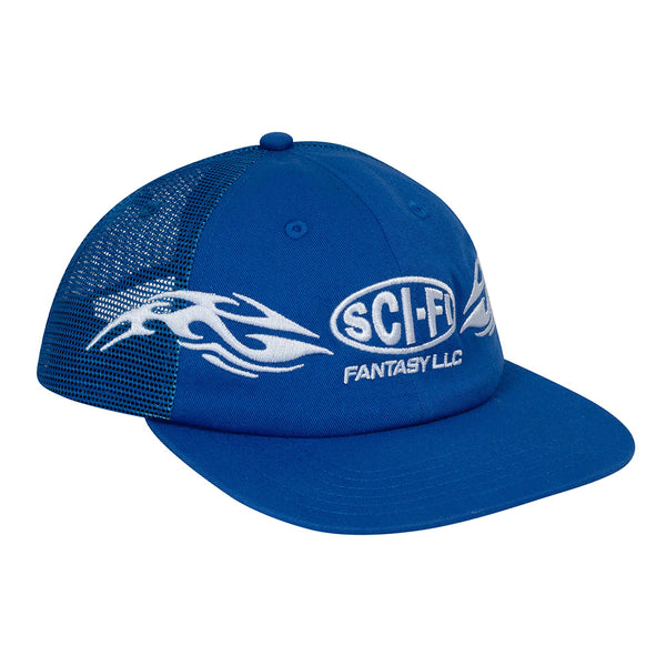 The SCI-FI FANTASY ORGIN MESH HAT ROYAL by SCI-FI FANTASY features a blue design with mesh back, white flame details, "SCI-FI FANTASY LLC" embroidery on the front, and a snapback closure for adjustable fit.