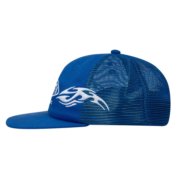 The SCI-FI FANTASY ORGIN MESH HAT ROYAL by SCI-FI FANTASY is a blue mesh trucker hat with a flat brim, white flame design on the side, and an adjustable snapback closure.