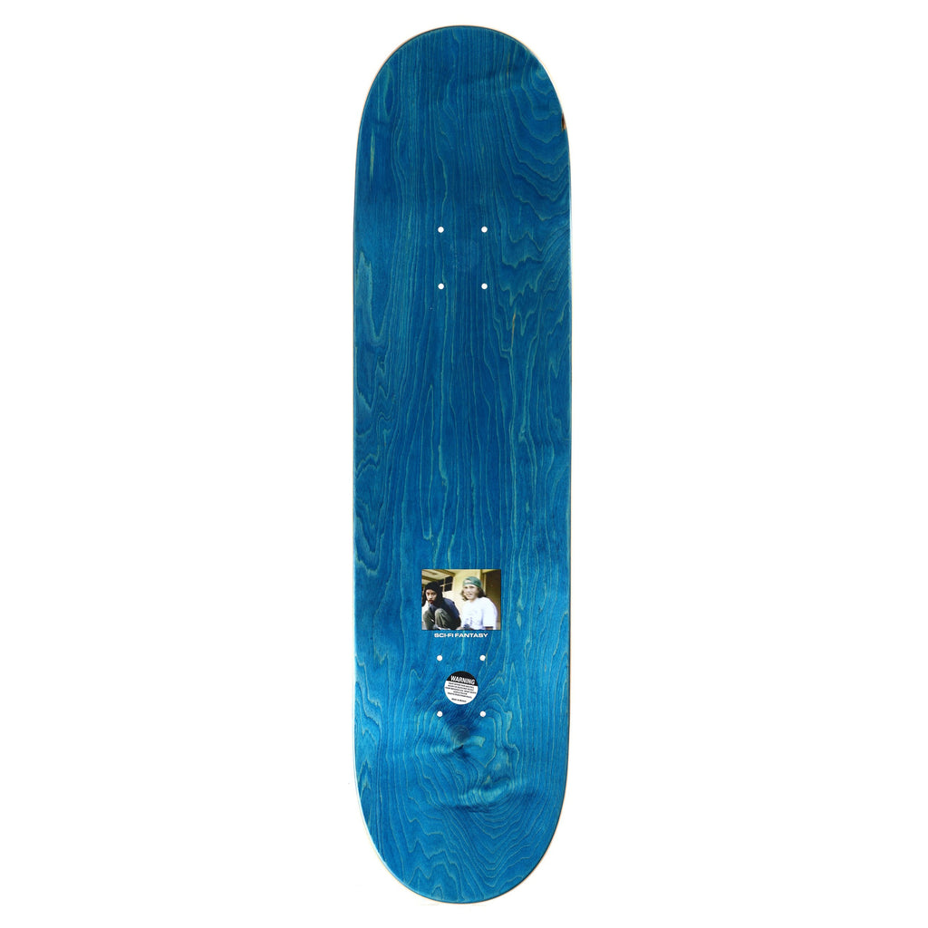 The SCI-FI FANTASY HSU BEAR SUIT skateboard deck, in blue, showcases a small, sci-fi fantasy-inspired image centered above the bottom truck holes.