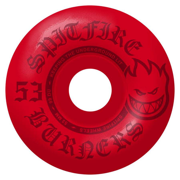 The SPITFIRE BURNERS 99D 53MM RED wheels are adorned with the iconic "SPITFIRE" branding and flame graphic. The "53 BURNERS" text emphasizes these entry-level Spitfire wheels, designed to light up the underground with their robust 99 Duro durability.