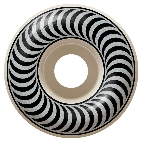 The SPITFIRE CLASSICS 99D 54MM features a black and white optical illusion design with concentric circles and crescent shapes, reminiscent of Spitfire's sleek style, adding artistic flair to its round form.