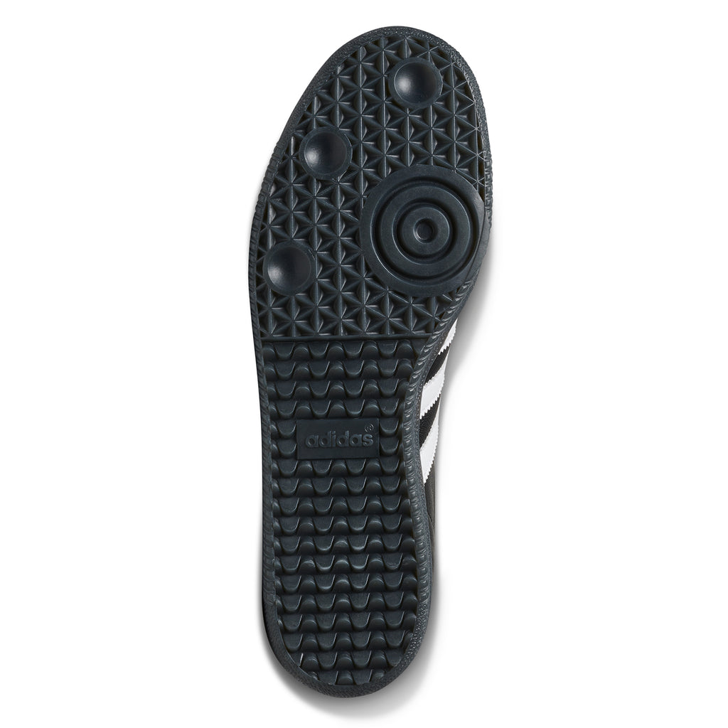 The patent leather sole of a black ADIDAS X FUCKING AWESOME SAMBA BLACK / BLACK / WHITE shoe on a white background.