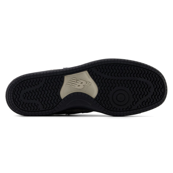 The back of a NB NUMERIC 480 TRAIL PACK GREY BLUE shoe with a white sole.