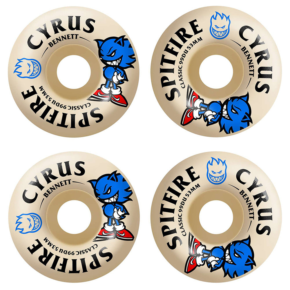 Four beige SPITFIRE skateboard wheels with blue cartoon graphics and "SPITFIRE F4 CYRUS BURN SQUAD CLASSIC 99D 53MM" printed in black and blue, featuring a medium width riding surface for balanced control.
