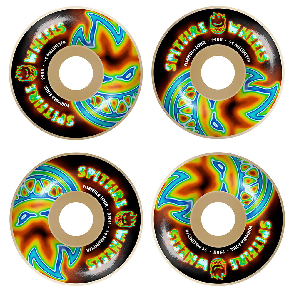 A set of four SPITFIRE F4 RADIOACTIVE CLASSIC BIG HEADS 99D 54MM skateboard wheels by SPITFIRE is displayed from above on a black background, with bold blue, green, and orange flame graphics.