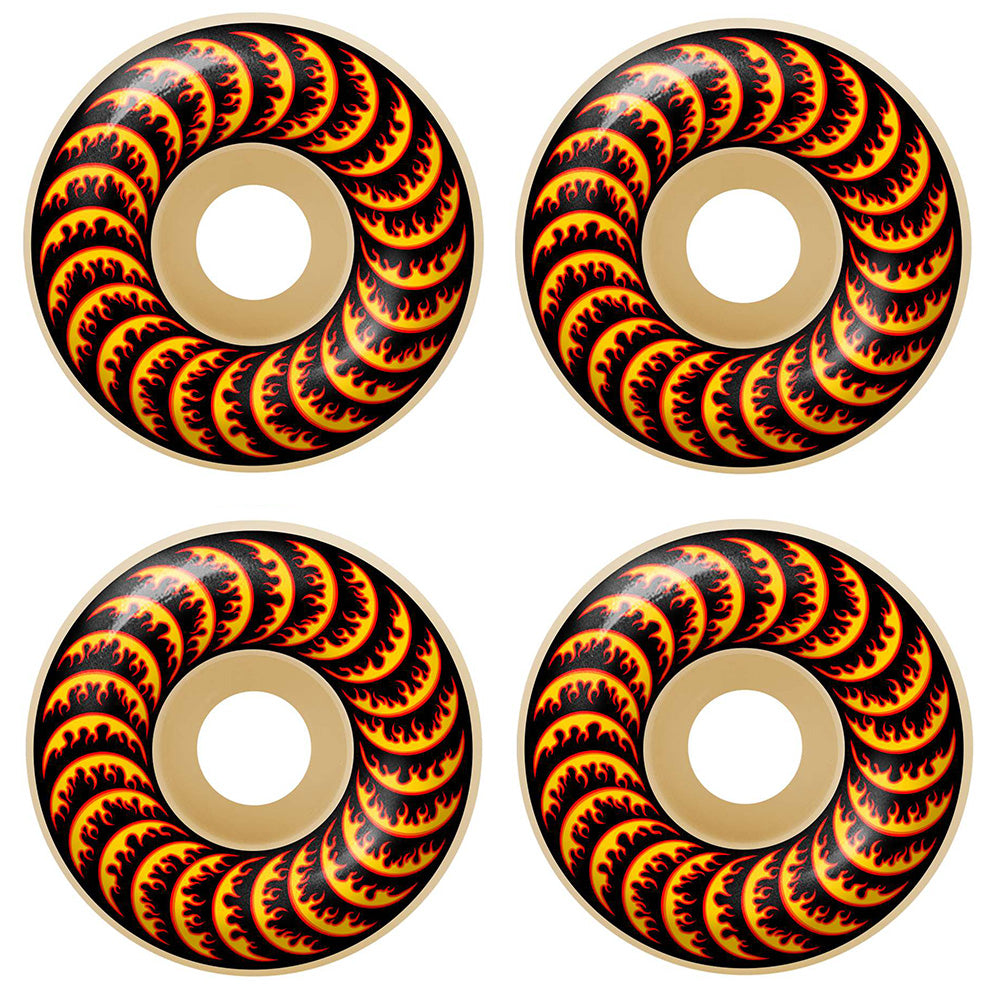 Four SPITFIRE X THRASHER F4 FLAME CLASSICS 99D 52MM skateboard wheels with a tan base and black-red flame design are displayed in a two-by-two grid, blending classic FORMULA FOUR style with THRASHER-inspired graphics.