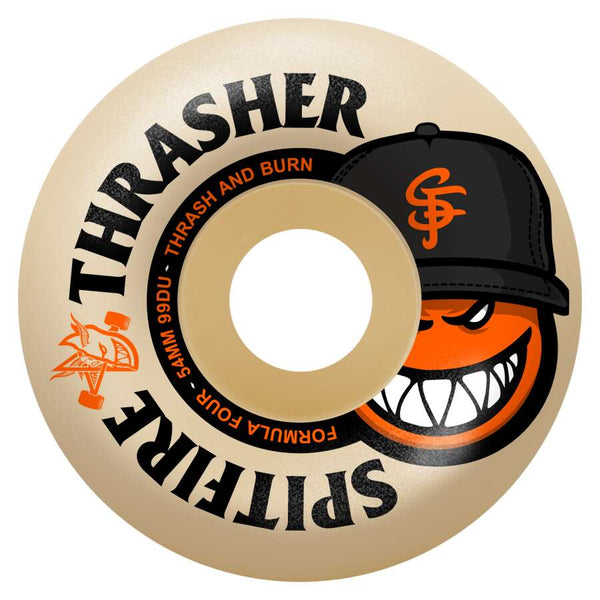 The SPITFIRE X THRASHER F4 THE CITY RADIAL FULL 99D 54MM skateboard wheel features iconic Thrasher and Spitfire branding, an orange grinning face with a black "SF" cap, and Formula Four performance for classic style.