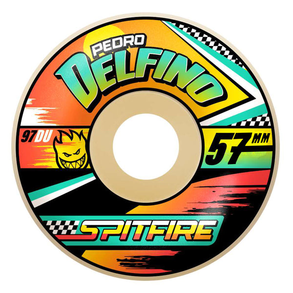 The SPITFIRE F4 DELFINO TURBO RADIALS 97D 57MM skateboard wheel boasts vibrant graphics featuring the text "Pedro Delfino," "Spitfire," and "97DU," adorned with various colored stripes and a grinning flame icon. Engineered by SPITFIRE, it ensures unbeatable performance and durability.