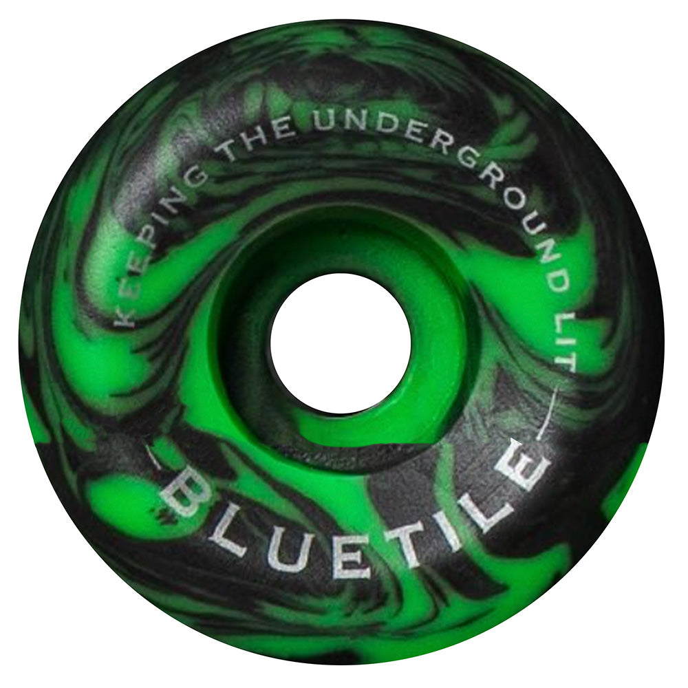 The SPITFIRE X BLUETILE CONICAL FULL 54MM in black/green swirl, featuring "KEEPING THE UNDERGROUND LIT" and "BLUETILE" graphics, delivers standout style and performance to any skateboard setup.