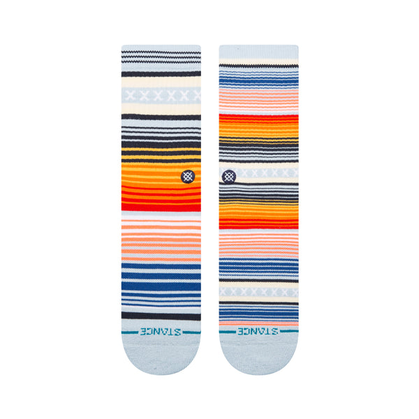 A pair of colorful STANCE SOCKS CURREN ST ICE BLUE LARGE laid flat, featuring a mix of horizontal lines in various colors such as blue, orange, yellow, and white. The word "STANCE" is printed near the toes of these lively Southbound Navy-themed accessories.