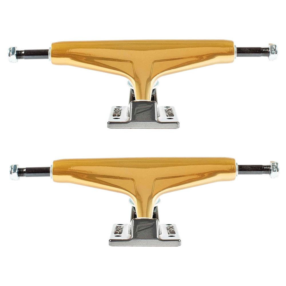 A set of two ollie's TENSOR MAG-LIGHT GLOSSY 5.5 GOLD/GUN METAL skateboard trucks are aligned horizontally against a white background.