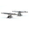 Two SLUSHCULT THOSE TRUCKS V.2 34MM FINGERBOARD TRUCKS in silver are displayed on a white background at different angles, showcasing their premium metal construction.