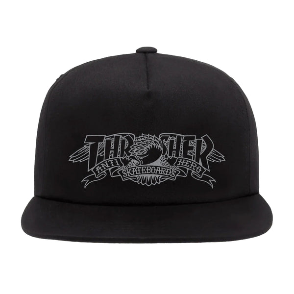 THRASHER THRASHER x ANTI HERO MAG BANNER SNAPBACK HAT BLACK with "Thrasher Skateboards" logo in gray, featuring an eagle design inspired by Antihero artwork.