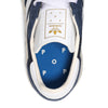 A pair of ADIDAS X POP TRADING CO. TRX VINTAGE NAVY/WHITE sneakers with the word pop on them.