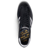 A black and white sneaker with a yellow logo on the side, inspired by ADIDAS X FUCKING AWESOME SAMBA BLACK / BLACK / WHITE.