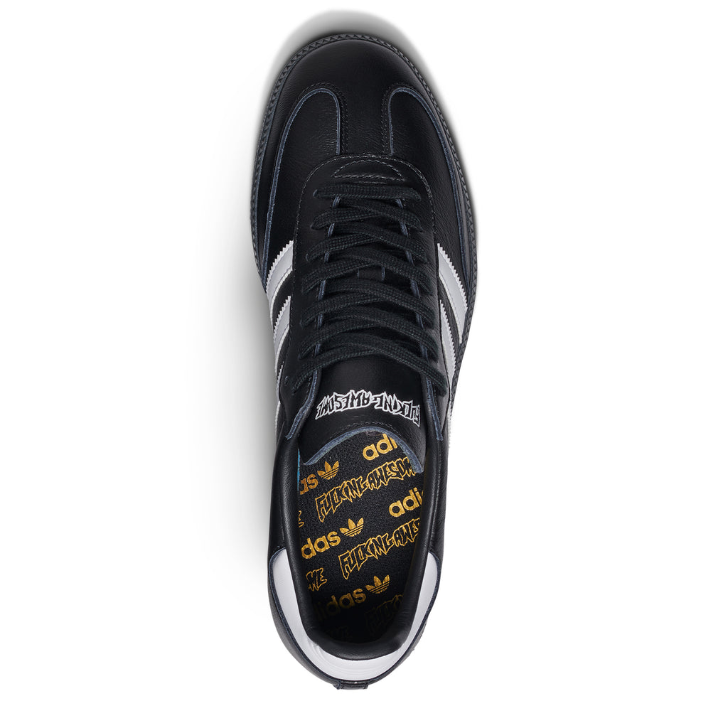 A black and white sneaker with a yellow logo on the side, inspired by ADIDAS X FUCKING AWESOME SAMBA BLACK / BLACK / WHITE.