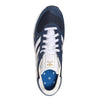 A pair of ADIDAS X POP TRADING CO. TRX VINTAGE NAVY/WHITE sneakers with a white sole.