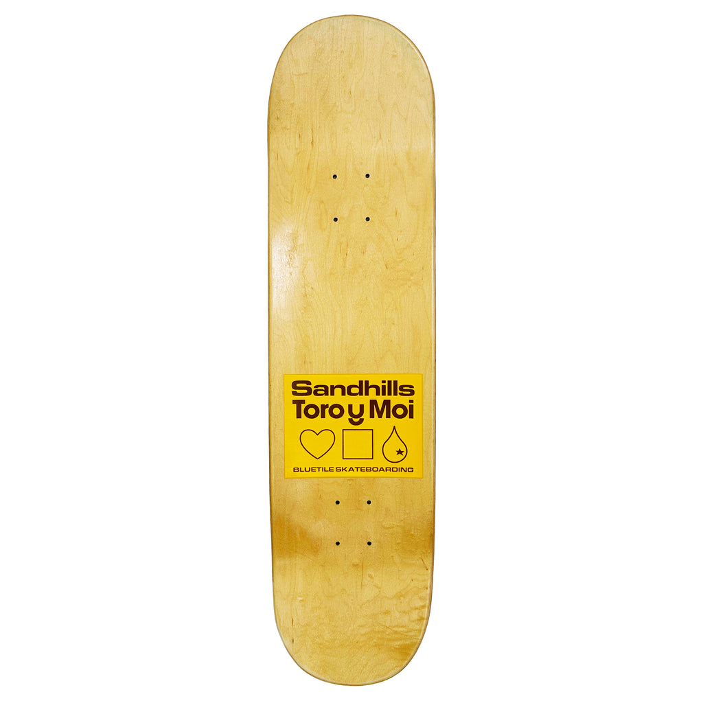 A skateboard with a yellow Bluetile Skateboards logo on it.