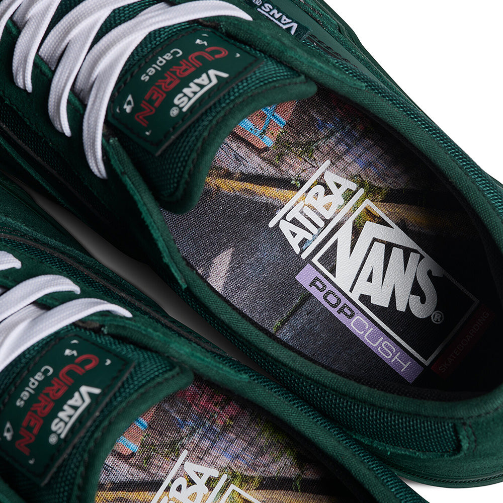 Close-up of emerald VANS X ATIBA SKATE CURREN CAPLES shoes with white laces, highlighting insoles with collaboration branding.