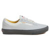 The VANS SKATE CURREN CAPLES GREY is a light gray low-top sneaker featuring white laces, yellow inner lining, a dark gray rubber sole, and POPCUSH insoles for enhanced comfort, shown in side profile.