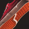 Close-up of the sole and side of VANS SKATE CURREN CAPLES RED / WHITE sneaker, highlighting white midsole, orange DURACAP outsole, POPCUSH insole, and detailed stitching.