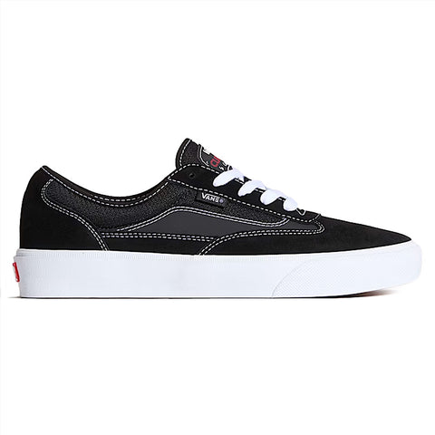 The VANS SKATE CURREN CAPLES BLACK / WHITE sneaker features a black low-top design with white laces, stitching, and sole, plus POPCUSH insoles. Shown in side profile against a plain background.