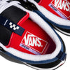 Close-up of VANS Skate Old Skool 36+ sneakers featuring "PopCush" insoles and DURACAP reinforcement. Sporting a navy and red design, the iconic Vans logo is visible on the red insole, crafted for both durability and style.