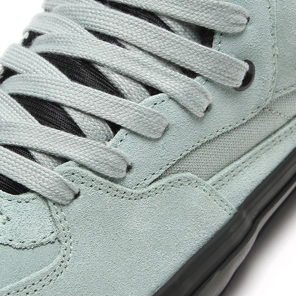 Close-up of VANS SKATE HALF CAB GREY OLIVE / BLACK sneakers, featuring grey laces and black details. These durable VANS skate shoes are ideal for skateboarding.