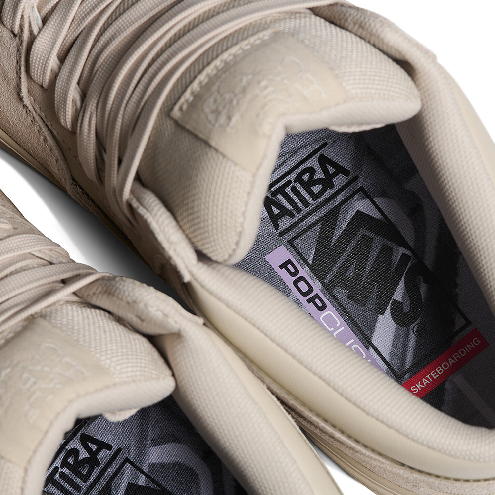Close-up of the VANS X ATIBA SKATE HALF CAB WAFFLE CUP OATMEAL BEIGE sneakers, highlighting patterned insoles with Vans, PopCush, and Skateboarding logos, plus a peek at the durable WaffleCup outsole made for skateboarding.