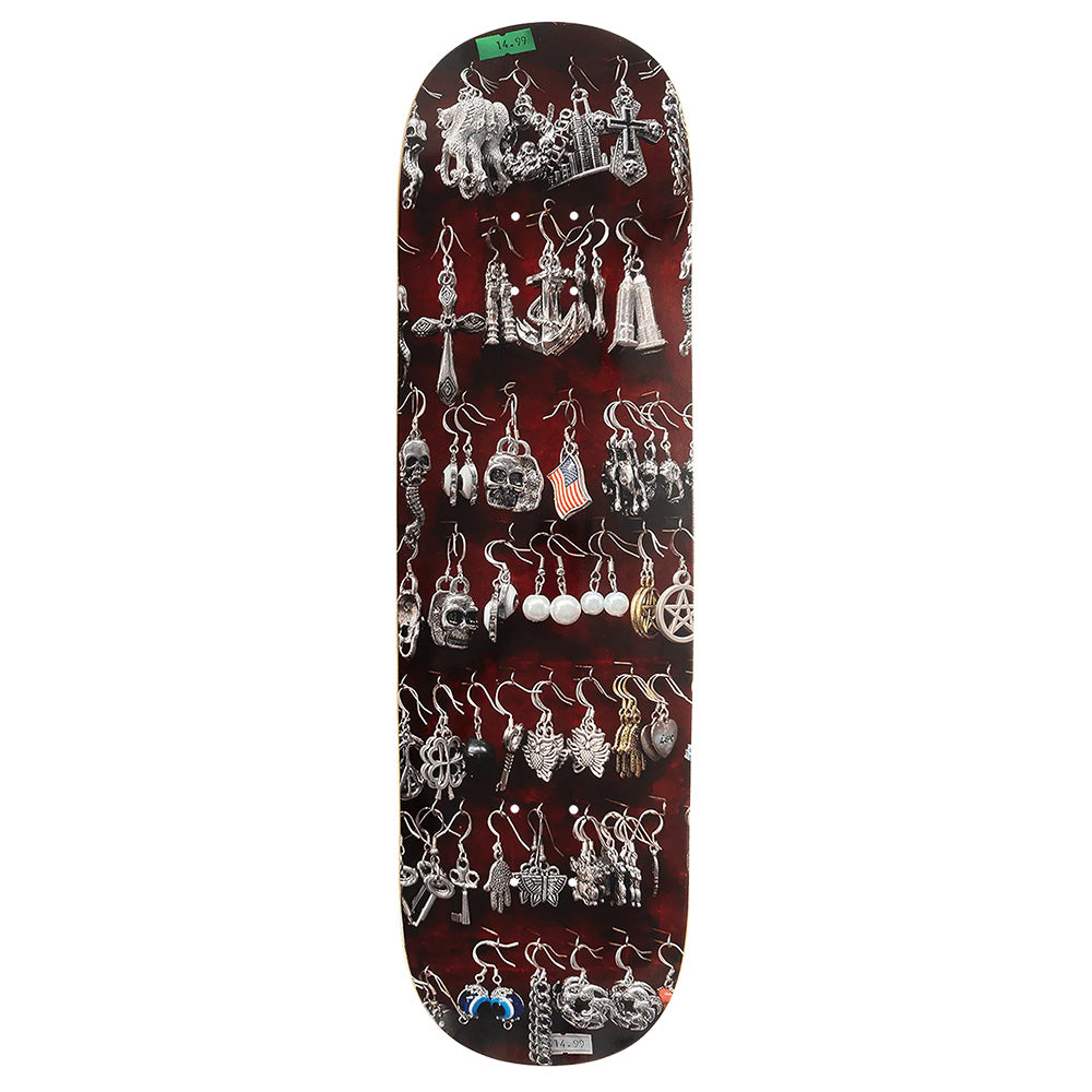 The VIOLET ST. MARK'S EARRINGS skateboard deck by violet features a graphic of silver earrings in rows on a dark background, inspired by William Strobeck's bold style.